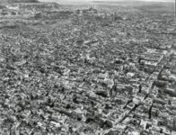 Aerial view of dense urban cityscape Aerial black and white photo showing a dense urban area with numerous buildings and streets.