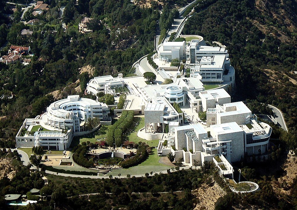 Aerial view of luxury mansion in hillside Aerial view of a large modern luxury mansion surrounded by trees and greenery in a hilly area
