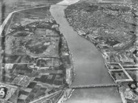 Aerial view of river with bridges and cityscape Aerial black and white photo of a wide river flowing through an urban area with bridges and surrounding buildings.