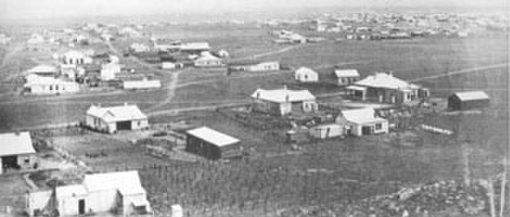 Aerial view of rural village and houses Aerial view of a small rural village with scattered houses and open fields, showcasing early settlement patterns.