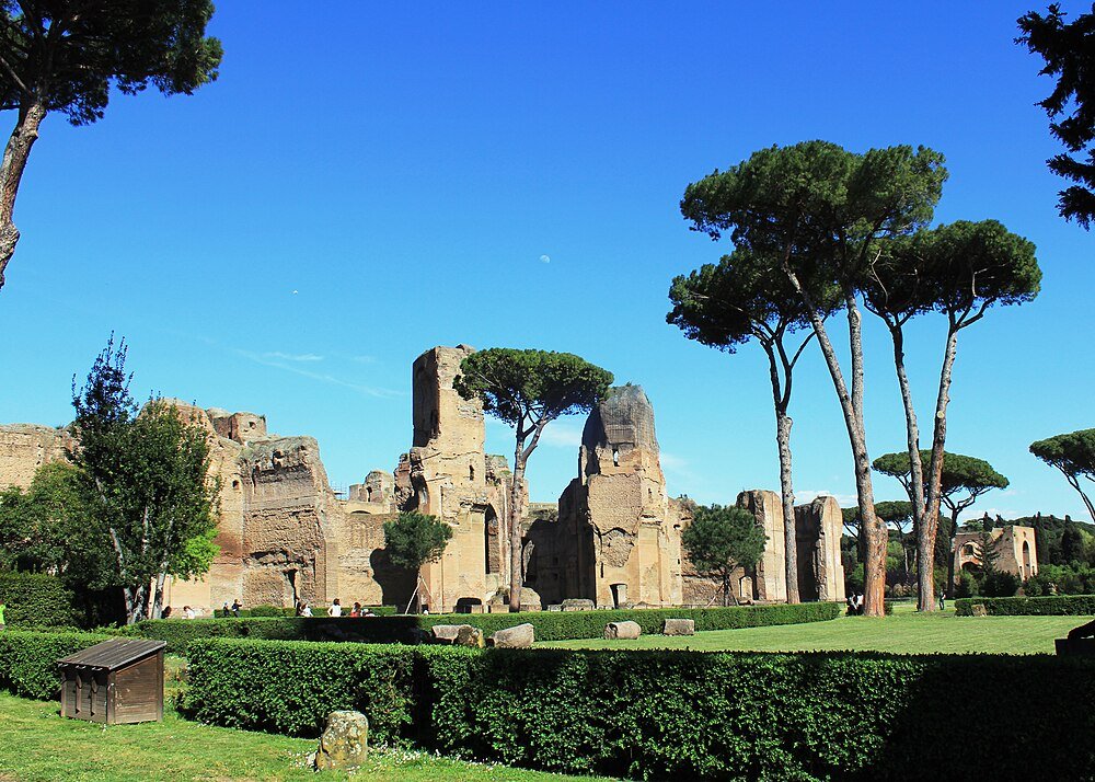 Ancient Roman Ruins with Pine Trees and Blue Sky Ancient Roman ruins with tall pine trees and clear blue sky in a well-maintained green park