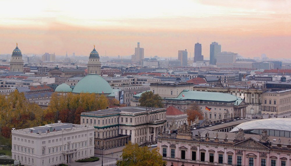 Berlin cityscape with historic and modern buildings Panoramic view of Berlin cityscape with historic buildings, domes, and modern skyscrapers during sunset in Germany