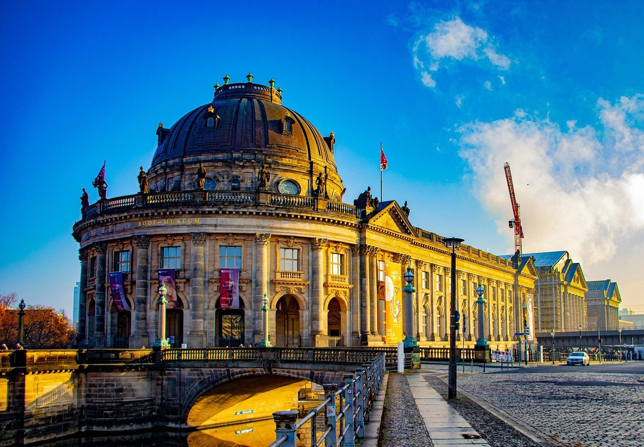 Bode Museum in Berlin with classical architecture and dome under clear blue sky during golden hour