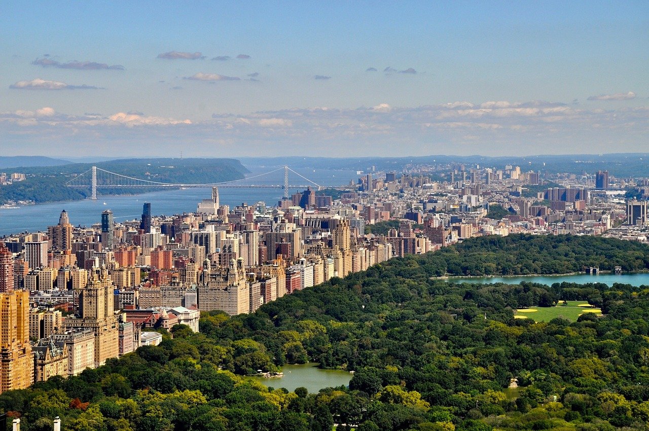 Aerial view of Central Park with surrounding Manhattan skyline and George Washington Bridge in New York City on a clear day