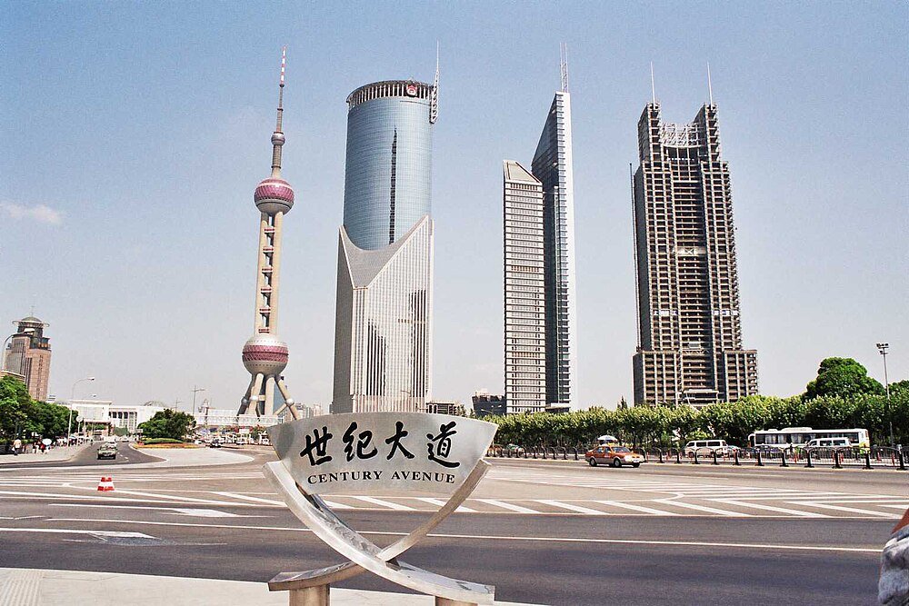 Century Avenue Shanghai skyline with Oriental Pearl Tower Century Avenue in Shanghai with iconic modern skyscrapers and Oriental Pearl Tower under clear blue sky