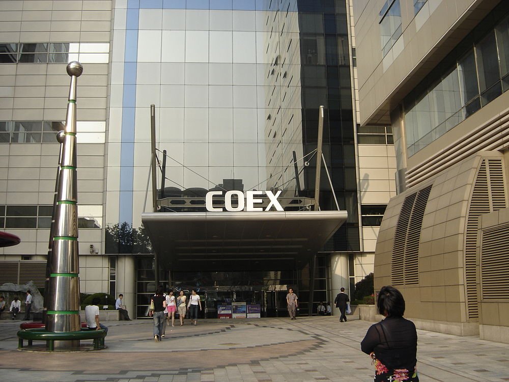 COEX building entrance in Seoul Entrance of COEX building with people walking and modern architecture in Seoul, South Korea