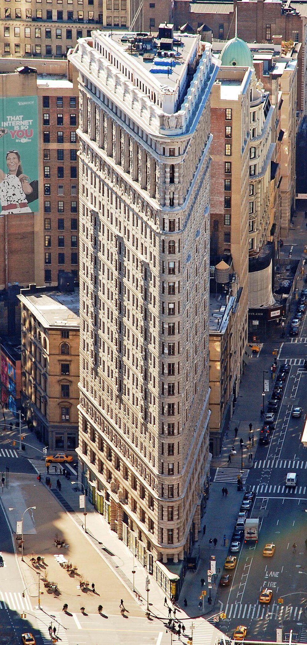 Flatiron Building New York City Landmark Iconic Flatiron Building in New York City with triangular shape and surrounding urban streets and traffic