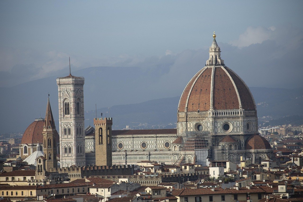 Florence Cathedral with iconic red dome and historic cityscape in Florence, Italy, showcasing Renaissance architecture