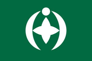 Green flag with white star and crescent emblem Green flag with a white circular emblem featuring a star shape and crescent-like curves symbolizing unity and harmony