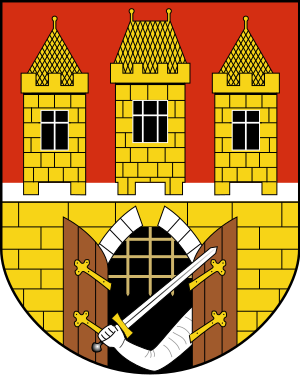 Heraldic coat of arms featuring three yellow brick towers with black windows and an armored arm holding a sword through an open gate