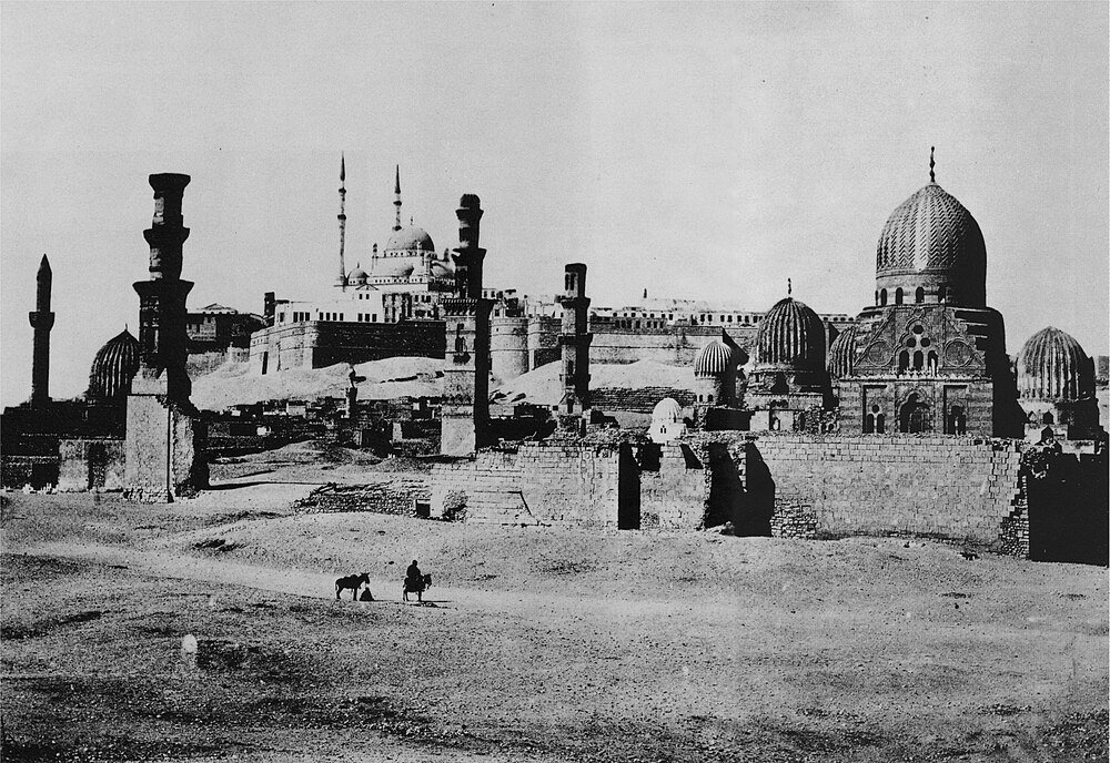 Historic Islamic Cairo with mosques and minarets Historic black and white photo of ancient Islamic Cairo with mosques, minarets, and domes in desert landscape