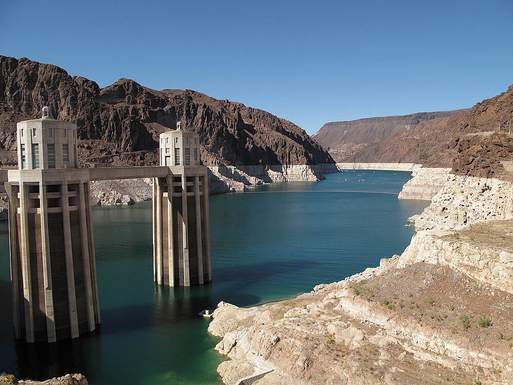 Hoover Dam intake towers and reservoir view Hoover Dam intake towers with water reservoir and rocky desert landscape under clear blue sky