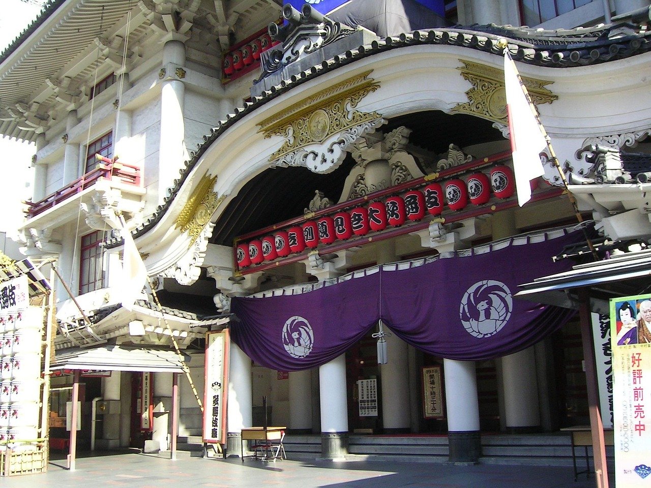 Traditional Japanese Kabuki theater entrance with ornate architecture, red lanterns, and purple curtains in Tokyo