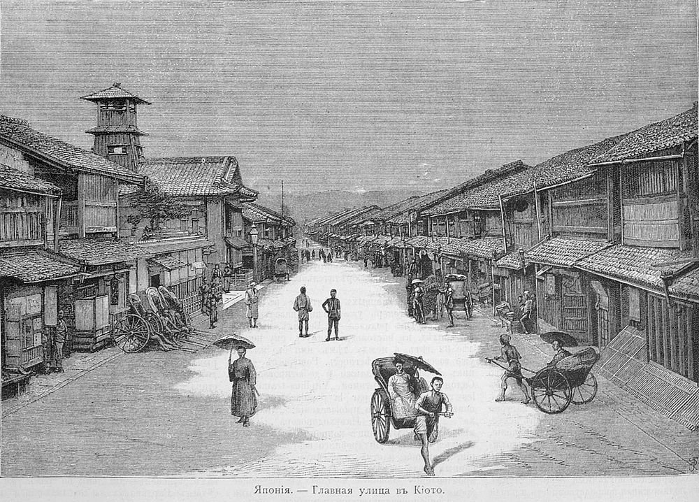 Main street in Kyoto, Japan with rickshaws Historic main street in Kyoto, Japan with traditional wooden buildings and people using rickshaws and umbrellas