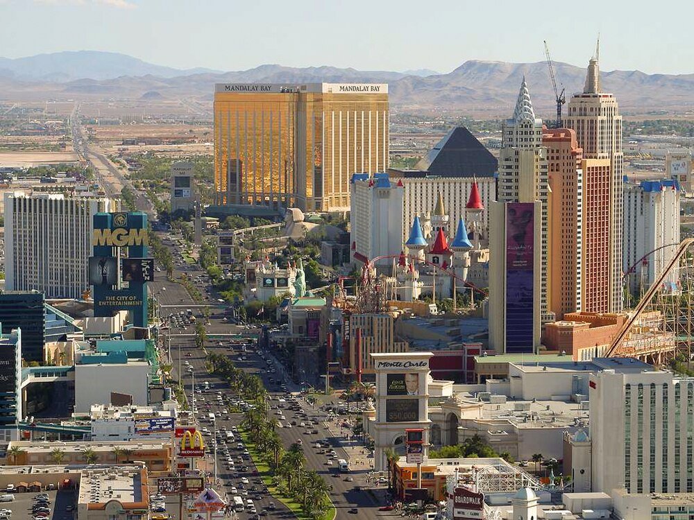 Las Vegas Strip casinos and hotels aerial view Aerial view of Las Vegas Strip featuring famous casinos like MGM, Mandalay Bay, and New York-New York with desert mountains in background