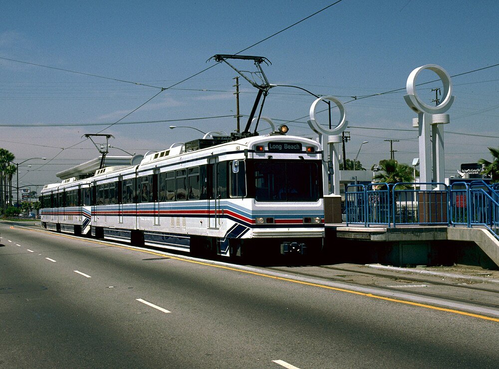 Light Rail Train at Long Beach Station Modern light rail train on Long Beach route at urban station with clear sky and overhead electric wires