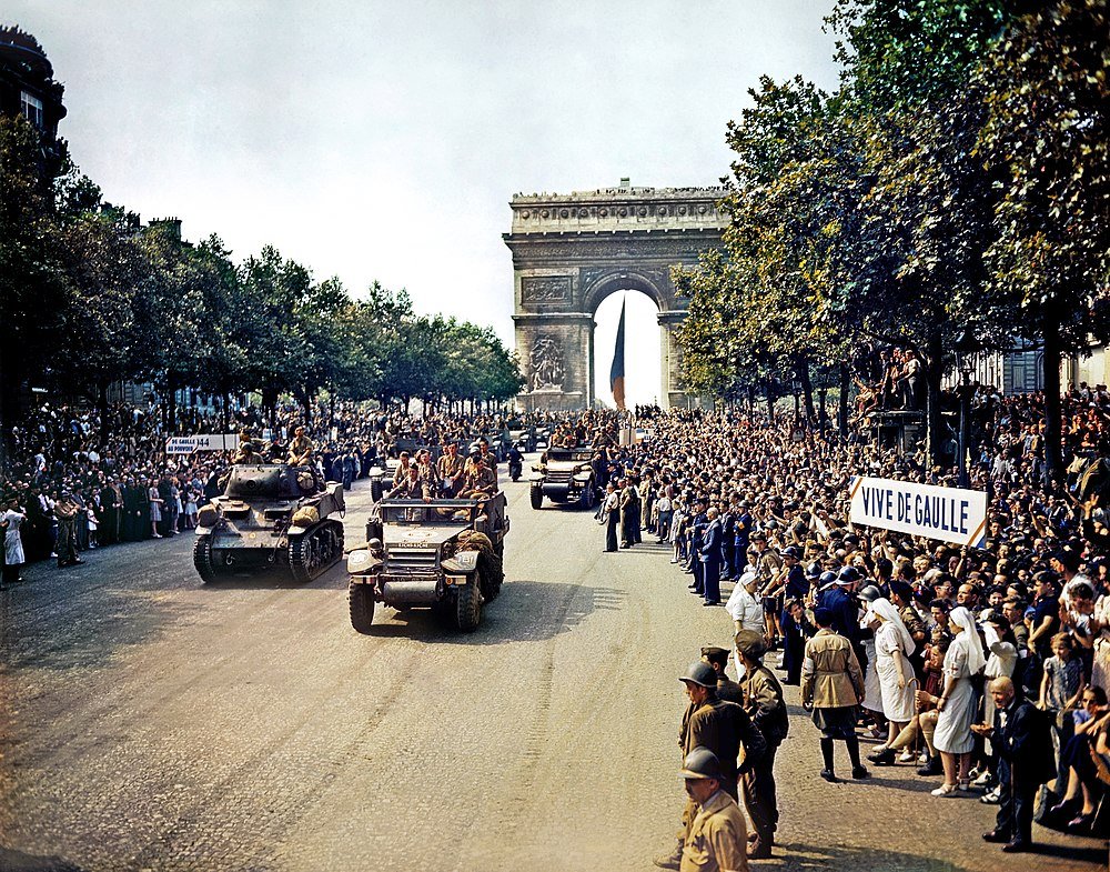 Military parade on Champs-Élysées near Arc de Triomphe Historic military parade with tanks and soldiers on Champs-Élysées in Paris near Arc de Triomphe, crowd holding Vive De Gaulle signs