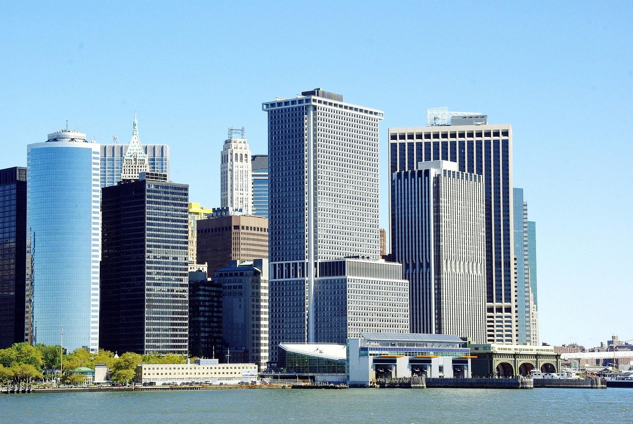 Skyline of modern skyscrapers and waterfront buildings in a major city under clear blue sky