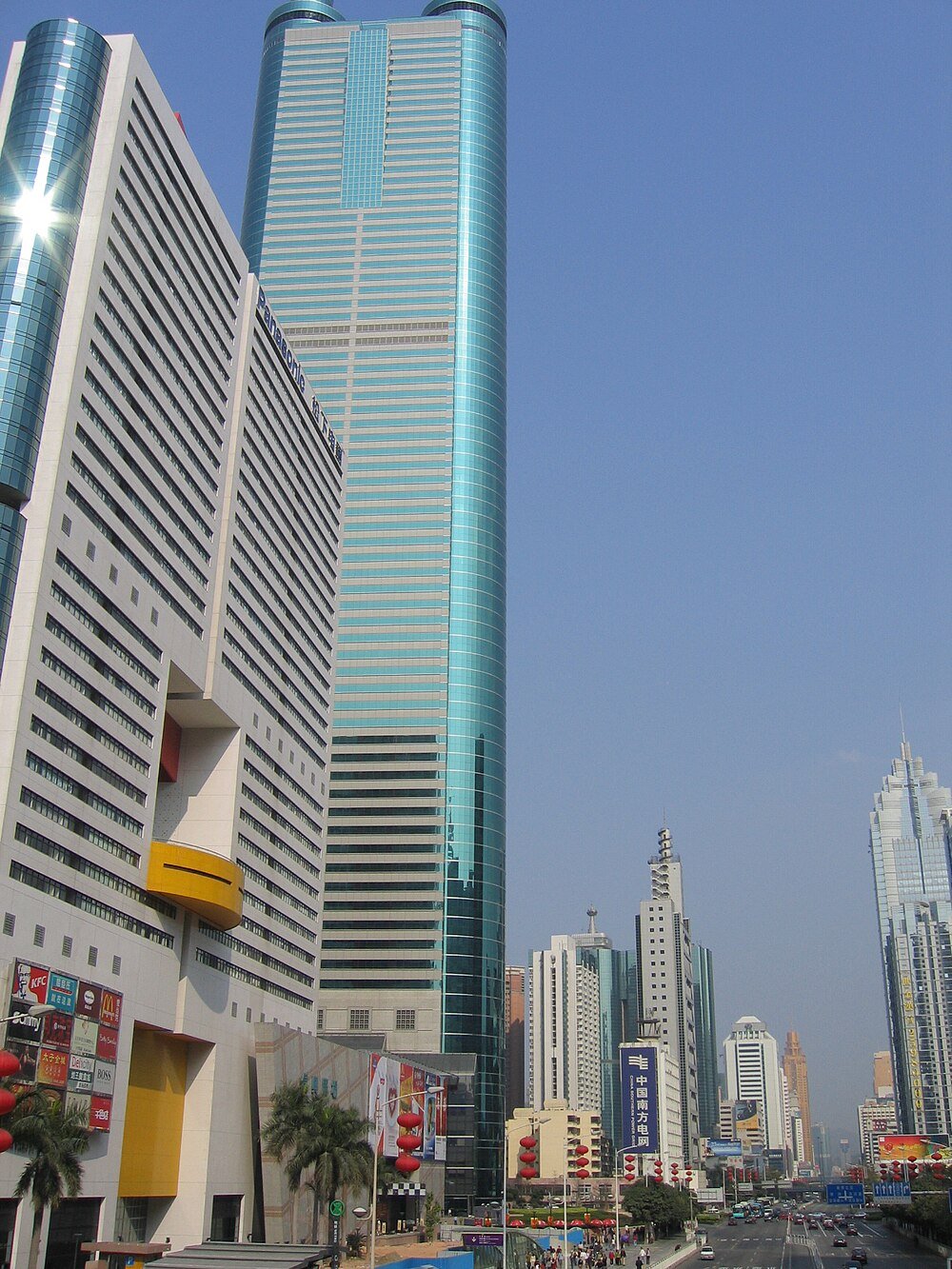 Skyscrapers and urban street in Chinese city Modern skyscrapers and busy urban street in a Chinese city with clear blue sky and commercial buildings