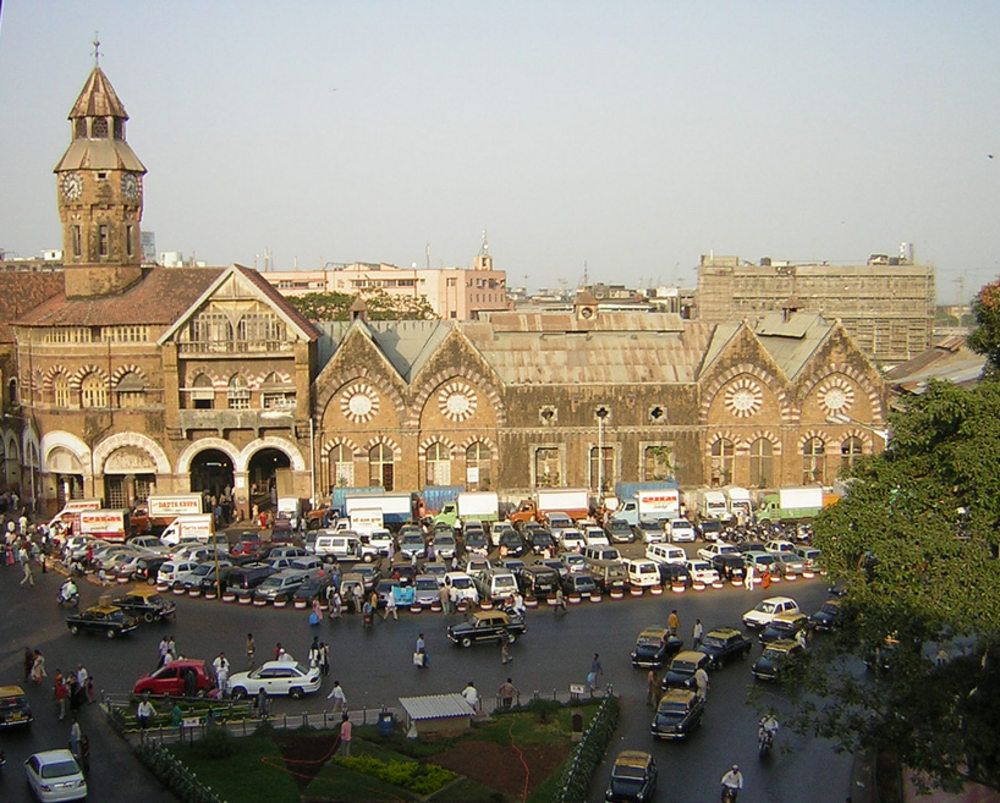 Mumbai CST Railway Station and Traffic Historic Mumbai CST railway station with vintage architecture and busy traffic in front, a major transport hub in India
