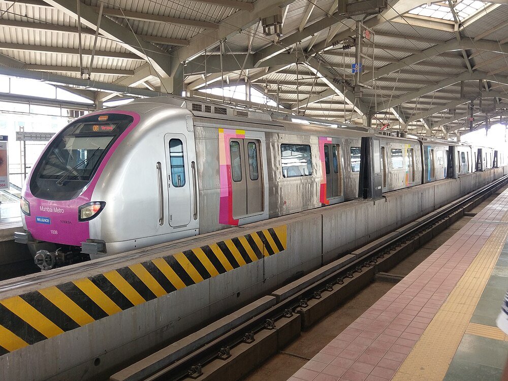 Mumbai Metro train at an elevated station platform with modern design and clear signage in India