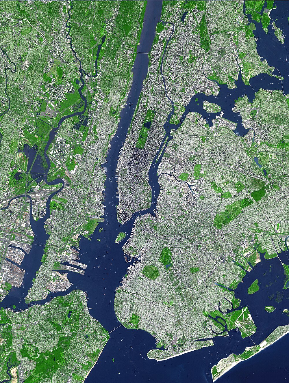 Satellite view of New York City and surrounding boroughs Aerial satellite view of New York City showing Manhattan, Brooklyn, Queens, and surrounding waterways with green parks