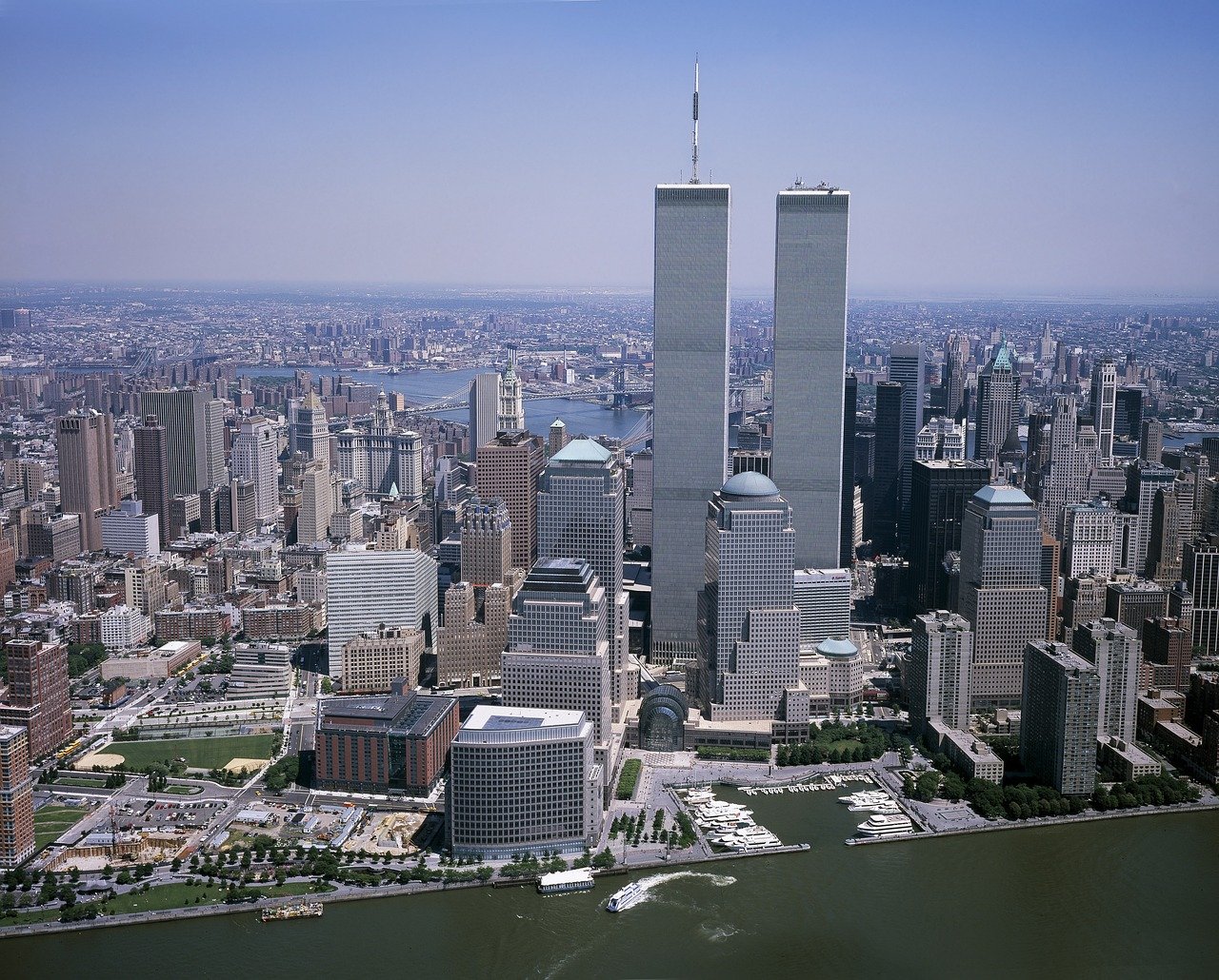 Aerial view of New York City skyline featuring the Twin Towers of the World Trade Center and surrounding buildings