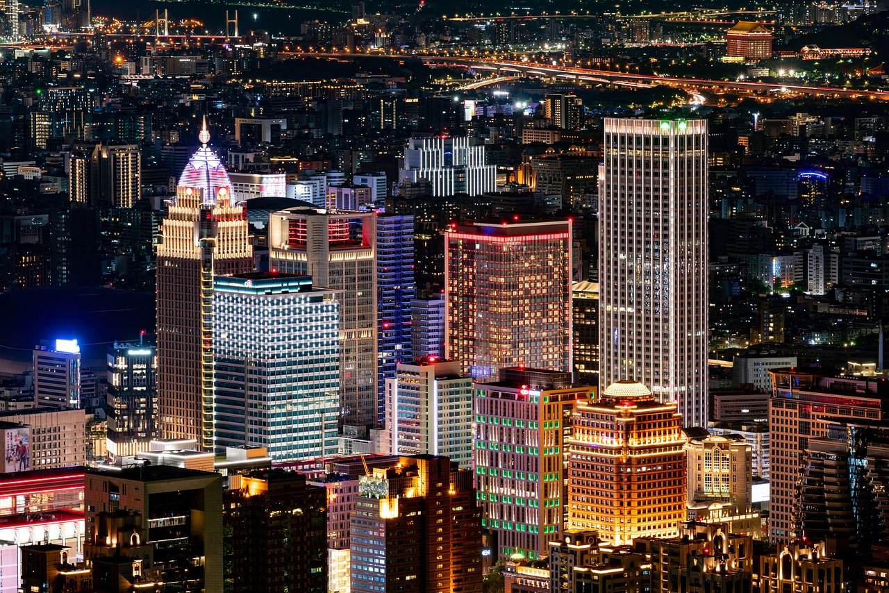 Night cityscape with illuminated skyscrapers, bridges, and urban buildings showcasing vibrant lights and architecture