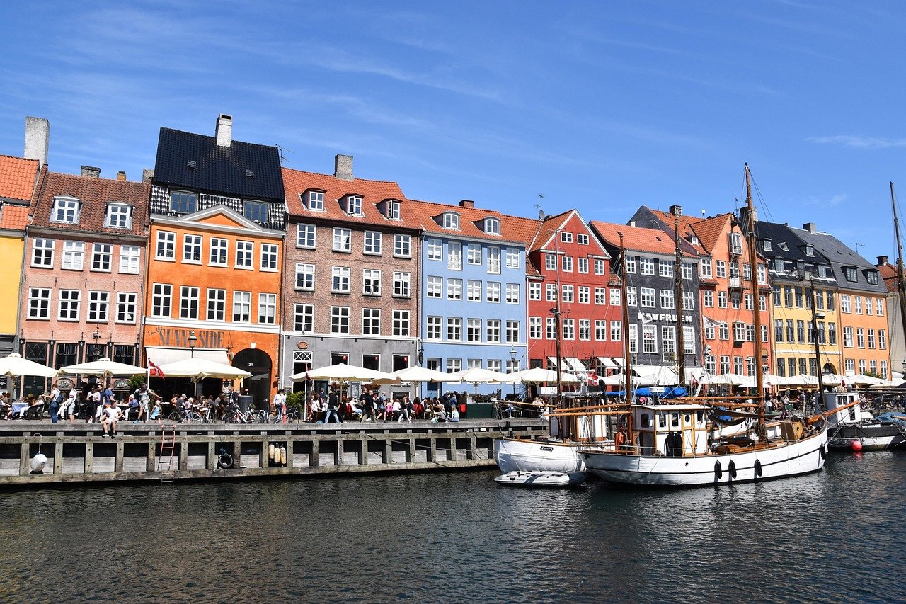 Colorful historic waterfront buildings and boats in Nyhavn, Copenhagen, a popular tourist destination in Denmark