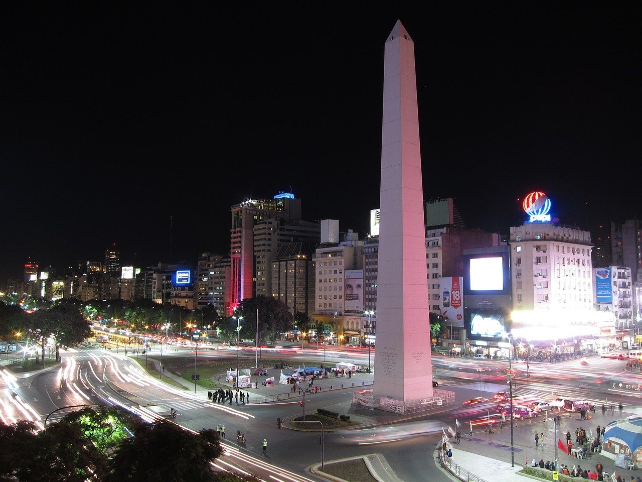 Night view of the Obelisk of Buenos Aires with light trails from traffic and illuminated city buildings