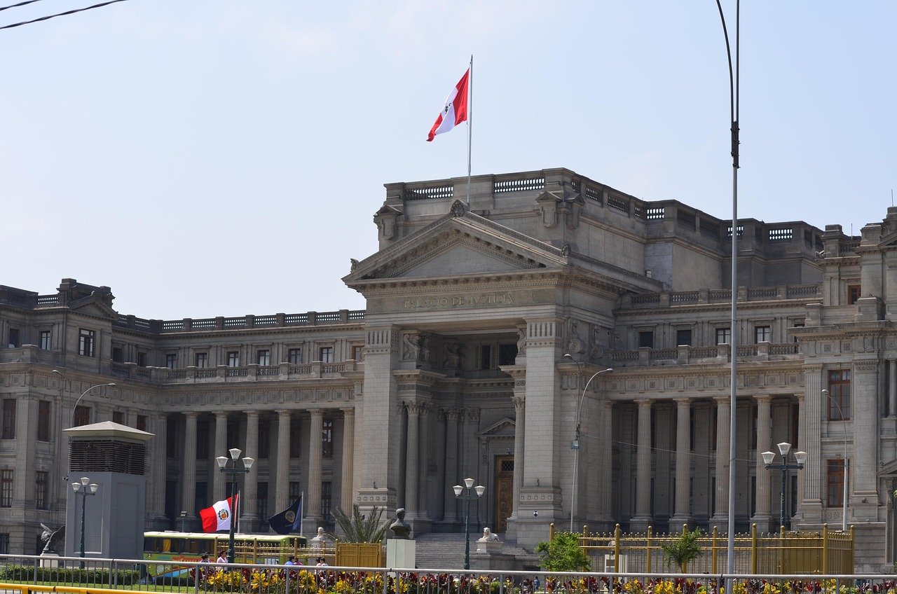 Palacio de Justicia building in Lima, Peru with Peruvian flag and classical architecture under clear sky