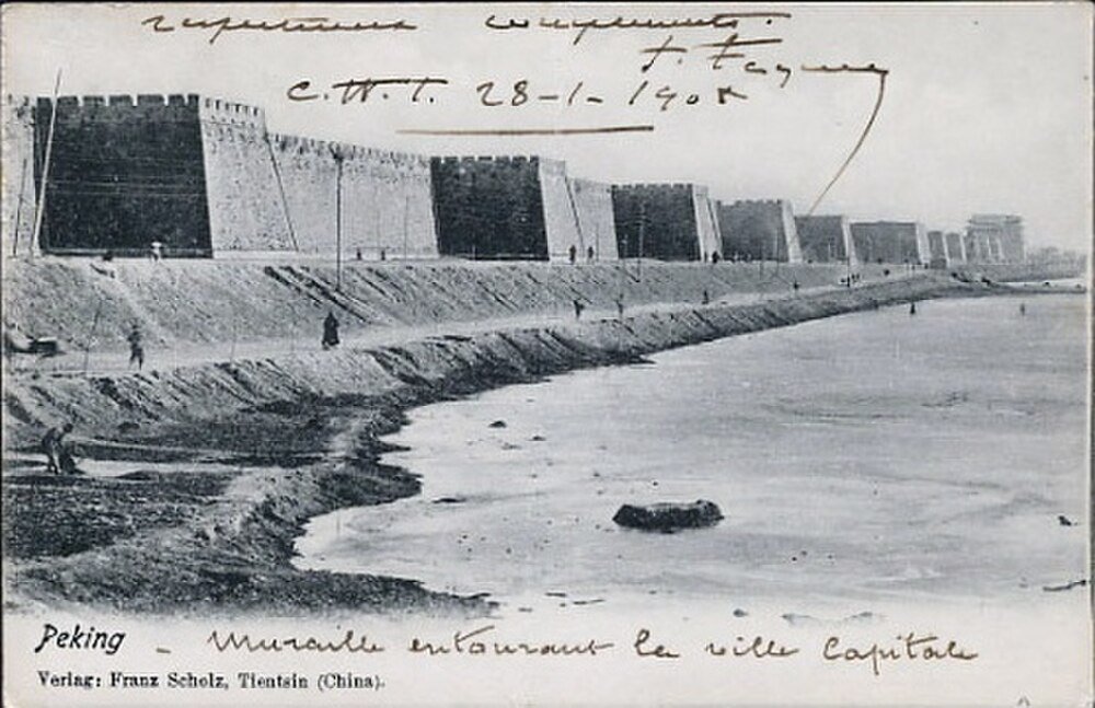 Peking City Wall and Moat Early 1900s Historic black and white photo of Peking city wall and moat with people walking along the water's edge in early 1900s China