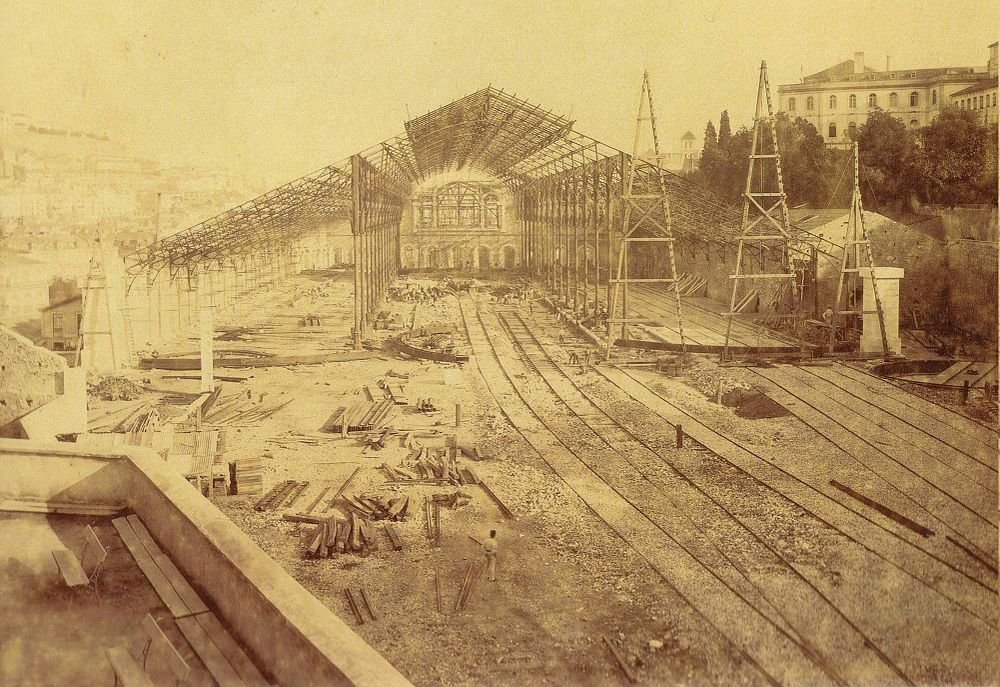 Railway station construction with steel framework and tracks Historic sepia photo of a large railway station under construction with steel framework and multiple train tracks