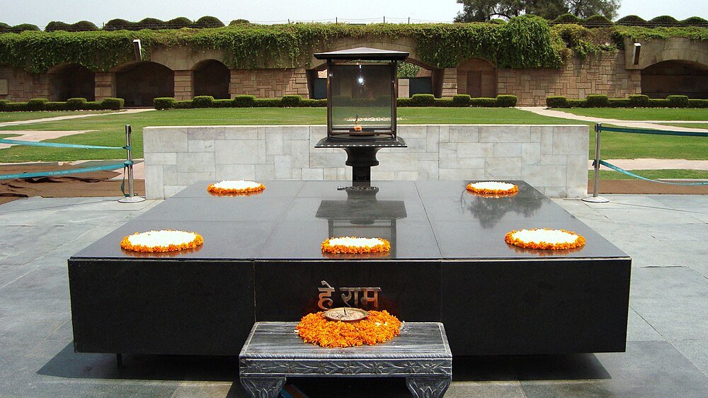 Raj Ghat Memorial with Marigold Garlands Raj Ghat memorial in Delhi India with black marble platform and orange marigold flower garlands