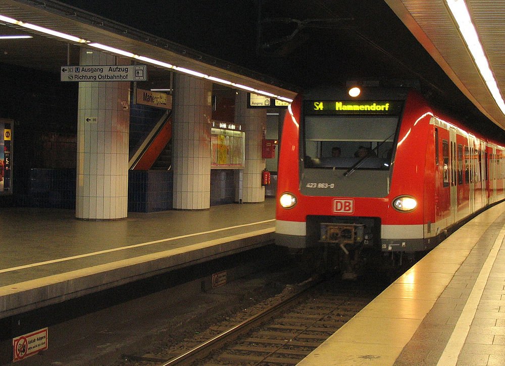 Red DB S-Bahn train at German underground station Red DB S-Bahn train arriving at a German underground station platform with signs in German language