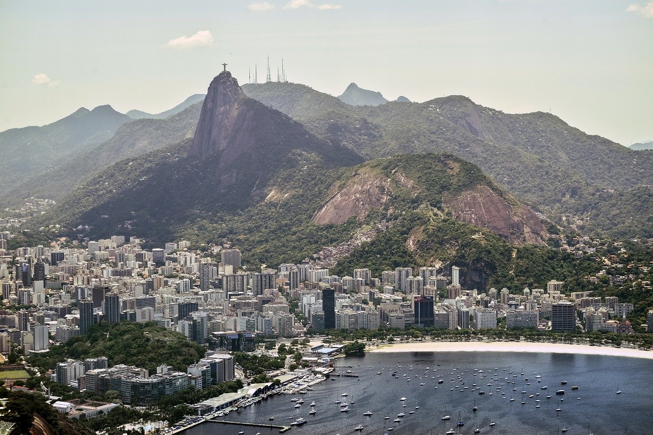 Aerial view of Rio de Janeiro cityscape with Christ the Redeemer statue and Sugarloaf Mountain in the background