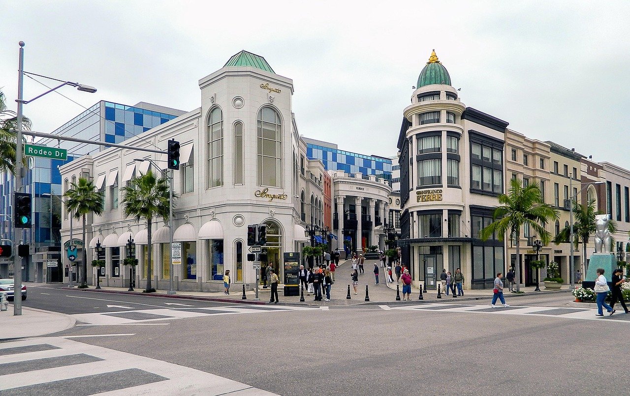 Luxury shopping district on Rodeo Drive with upscale boutiques, pedestrians, and iconic architecture in Beverly Hills