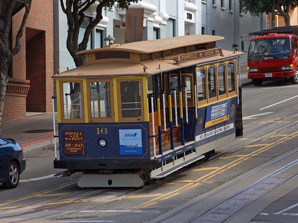 San Francisco cable car number 16 on Powell and Hyde street line near downtown with surrounding vehicles