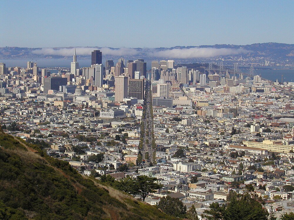 San Francisco city skyline with Bay Bridge Aerial view of San Francisco cityscape with downtown skyscrapers, streets, and the Bay Bridge in the background on a clear day