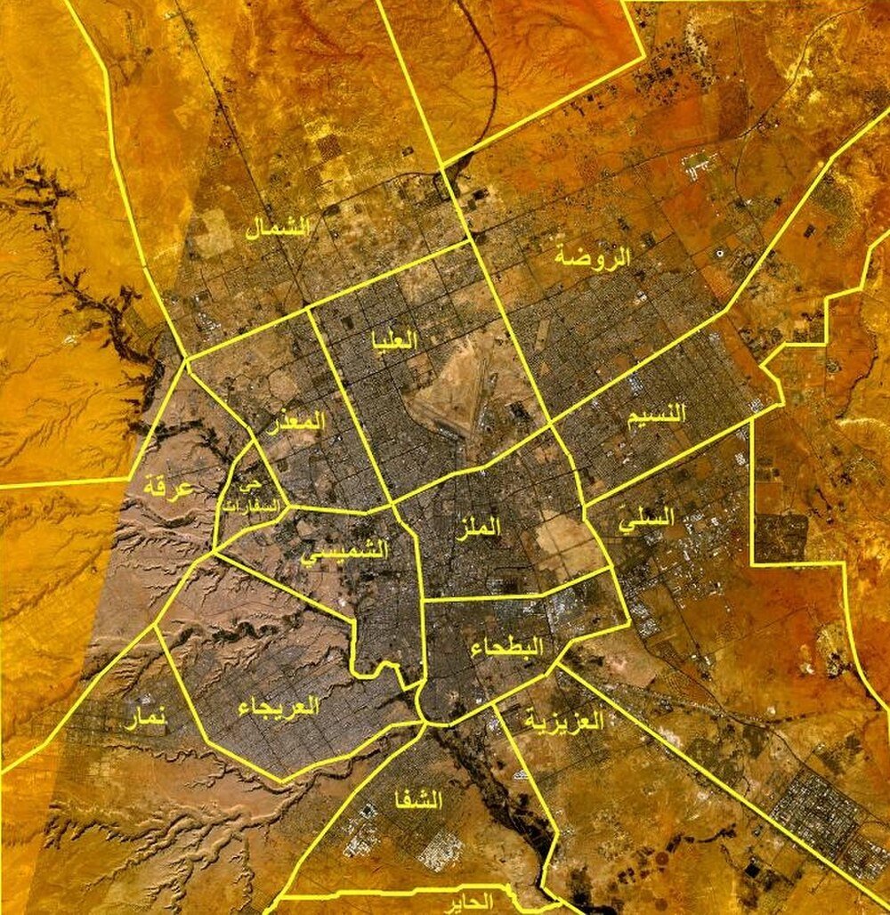 Satellite city map with Arabic district labels Satellite map showing detailed districts and boundaries of a city with Arabic labels and yellow borders