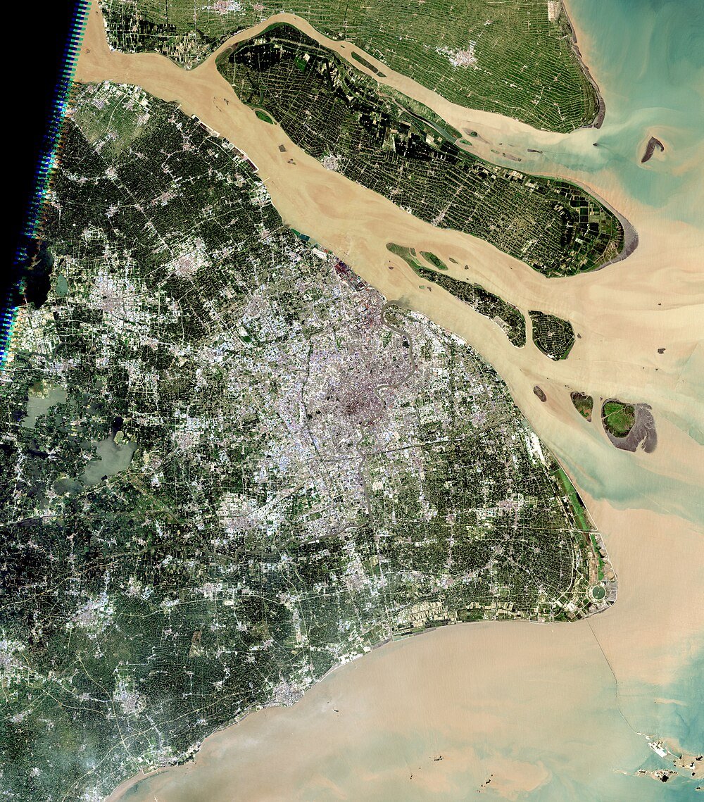 Satellite view of urban area with rivers and greenery Satellite image of a large urban area with rivers and green patches showing city layout and water bodies