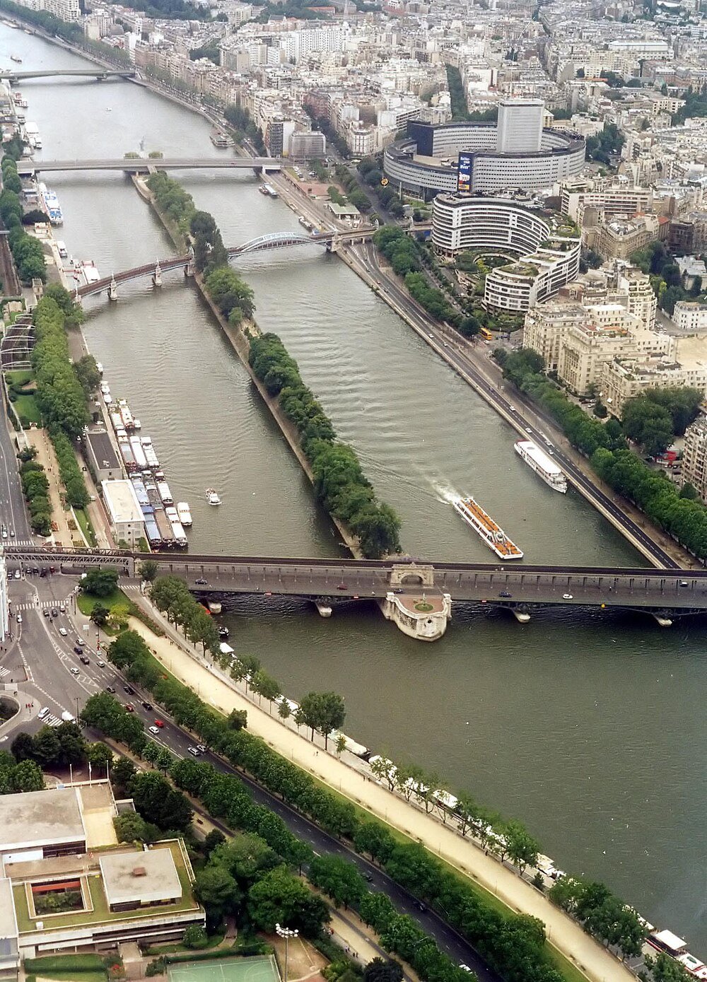 Aerial view of Seine River and bridges in Paris Aerial view of the Seine River with multiple bridges and boats in Paris, showcasing urban architecture and greenery.