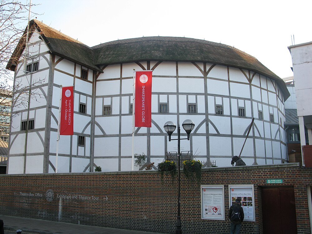 Shakespeare's Globe Theatre exterior in London Exterior view of Shakespeare's Globe Theatre in London with white walls, timber framing, and thatched roof