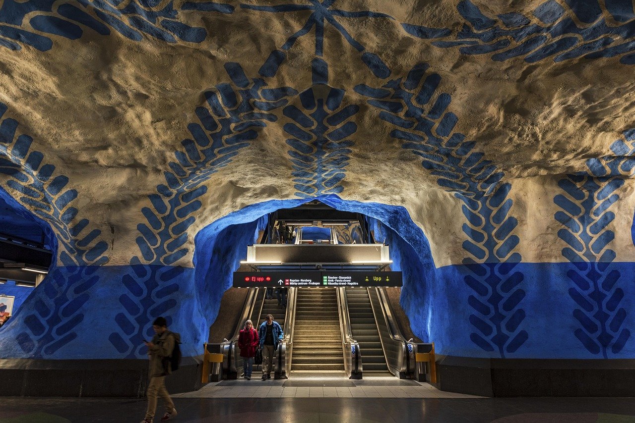 Colorful underground metro station with artistic blue and beige cave-like walls and escalators in Stockholm, Sweden