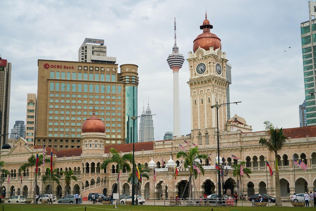 Sultan Abdul Samad Building with clock tower and Kuala Lumpur Tower in the background, Kuala Lumpur cityscape