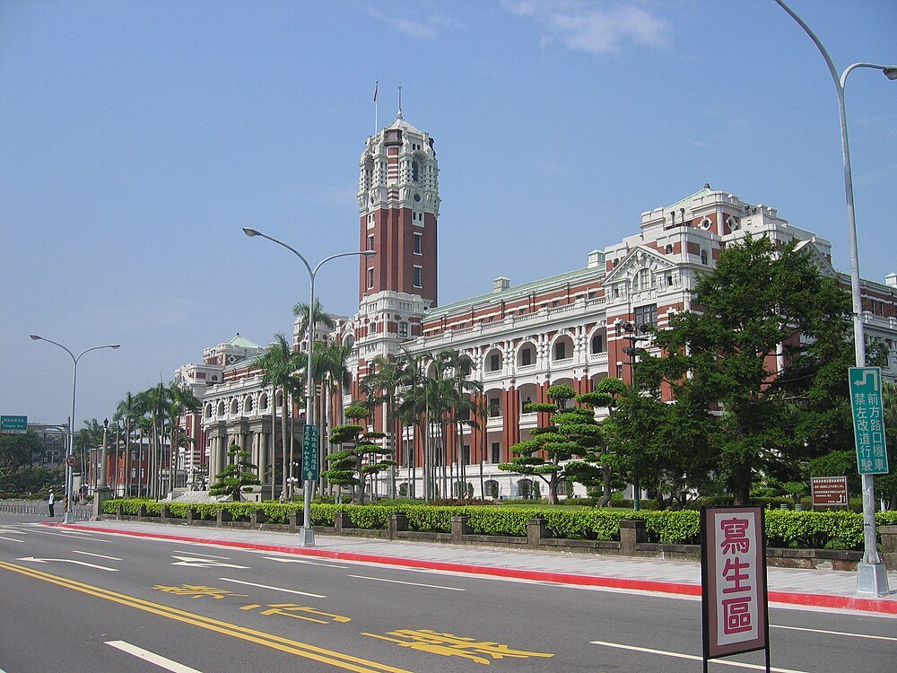 Historic government building with clock tower in Taipei Historic red and white government building with clock tower and palm trees along a wide street in Taipei, Taiwan
