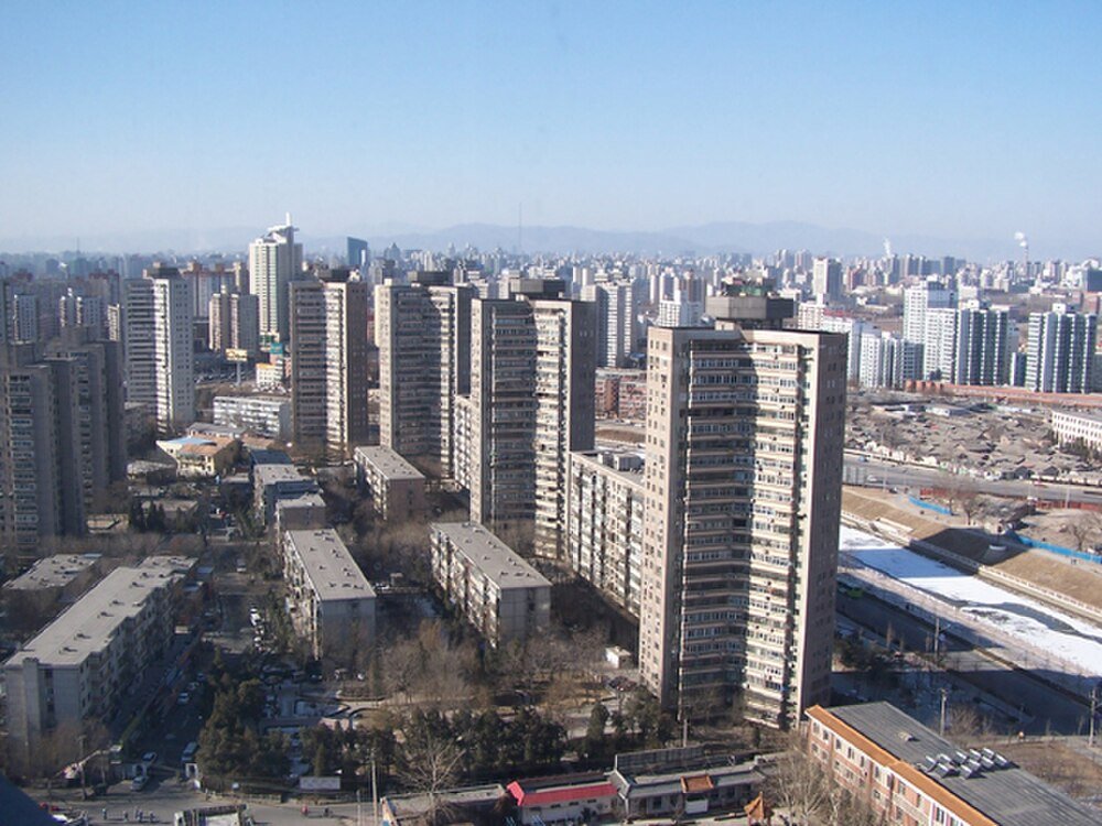 Urban high-rise residential buildings with clear sky High-rise residential buildings in a densely populated urban area with clear blue sky and distant mountains