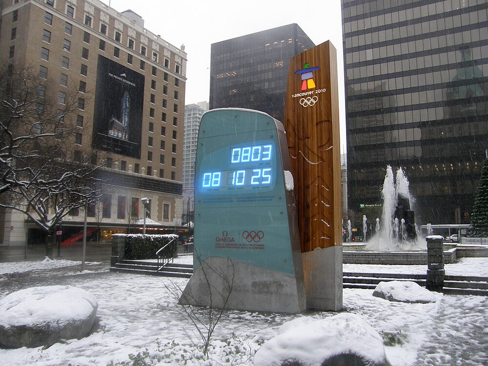 Vancouver 2010 Winter Olympics Countdown Clock Vancouver 2010 Winter Olympics countdown clock in snowy urban plaza with surrounding buildings and fountain