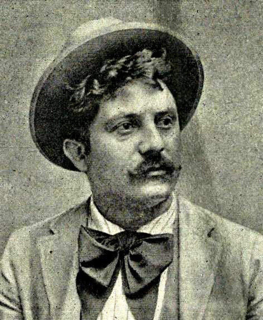 Vintage portrait of man with bow tie and hat Vintage black and white portrait of a man with a mustache wearing a bow tie and hat, early 20th century style