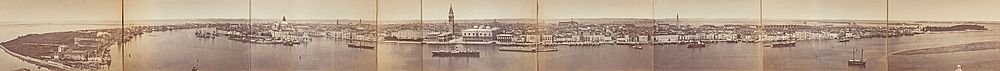 Vintage panoramic waterfront cityscape photo Panoramic sepia-toned vintage photograph of a historic waterfront cityscape with boats and prominent buildings.
